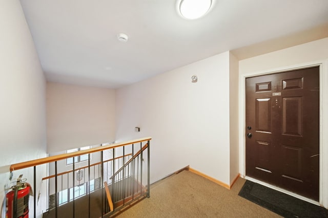 view of carpeted entrance foyer