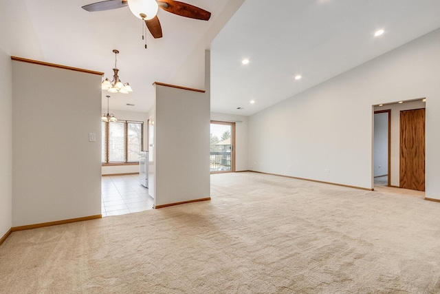 unfurnished room featuring light carpet, high vaulted ceiling, ceiling fan with notable chandelier, and baseboards