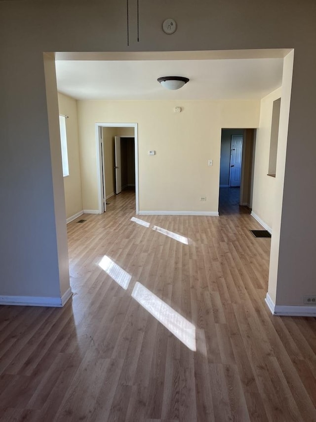 empty room with hardwood / wood-style flooring