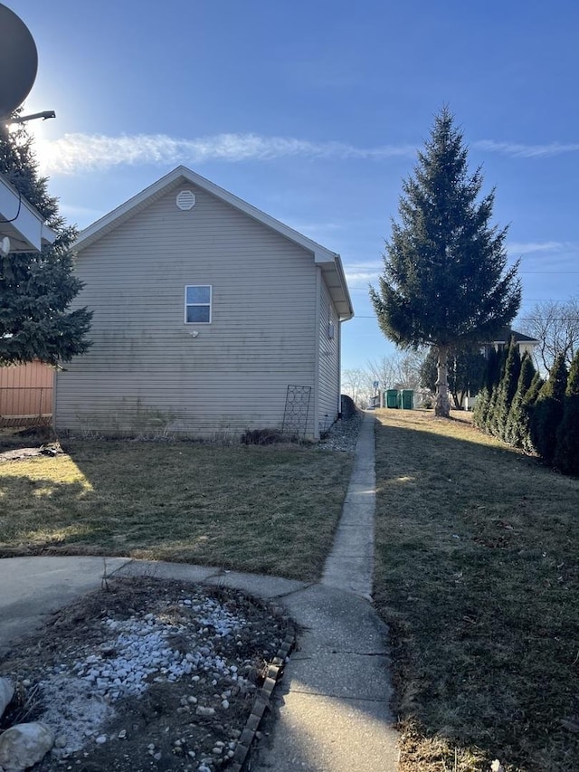 view of side of home featuring a yard