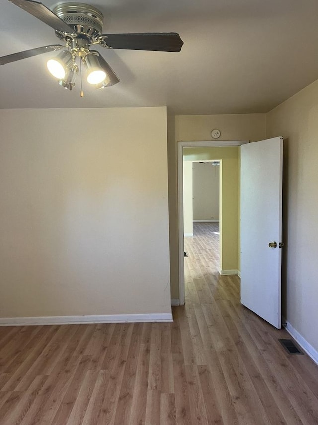 spare room featuring ceiling fan and light hardwood / wood-style flooring