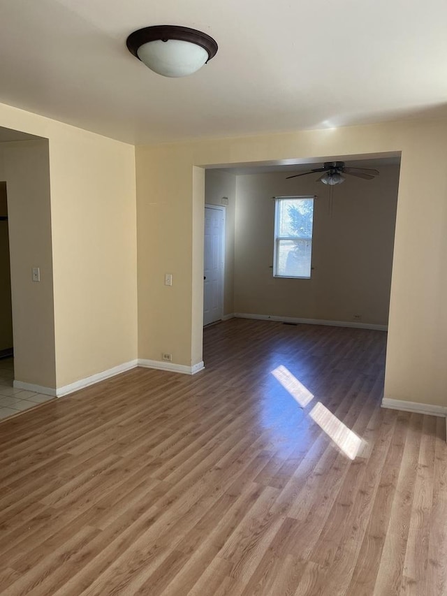 spare room with ceiling fan and light hardwood / wood-style flooring