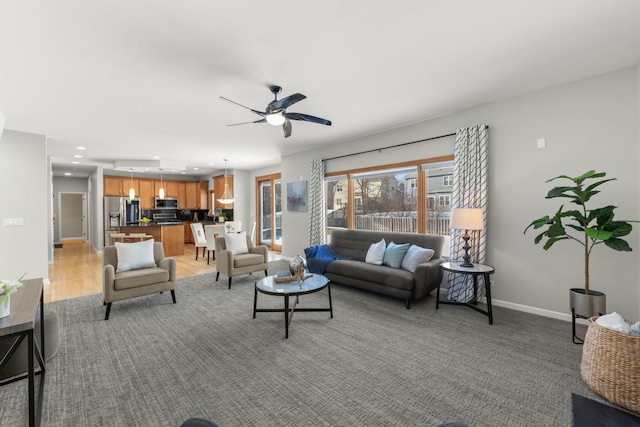 living room with recessed lighting, a ceiling fan, and baseboards