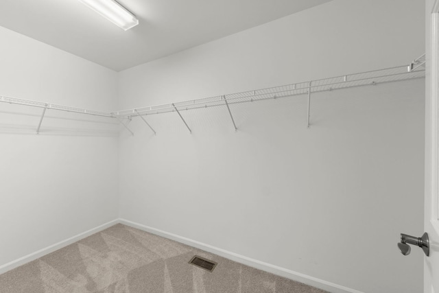 walk in closet with carpet floors and visible vents