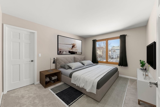 carpeted bedroom featuring baseboards