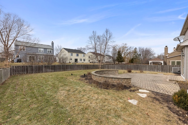 view of yard with a residential view, a patio area, and a fenced backyard