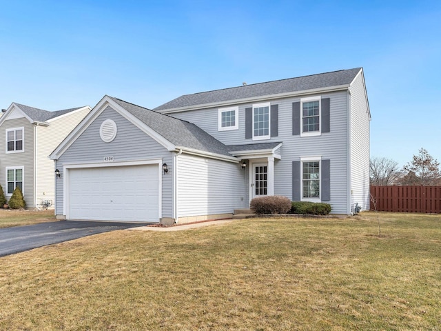 view of front of house with a garage and a front yard