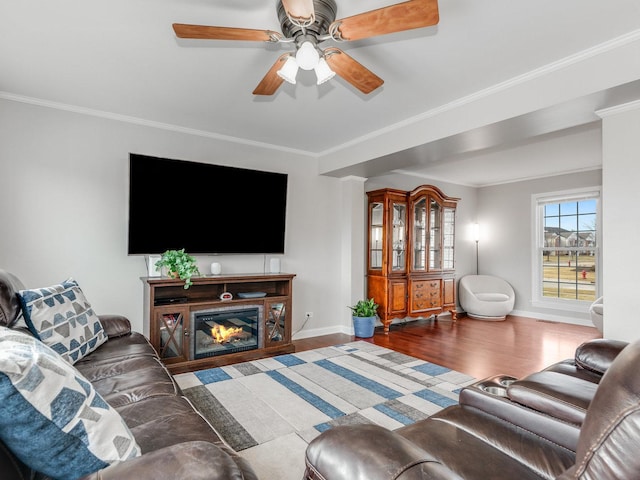 living room featuring crown molding, ceiling fan, and wood-type flooring