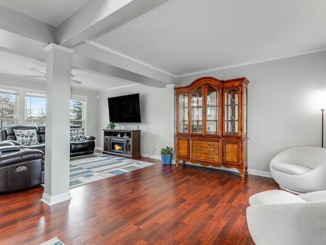 living room with dark hardwood / wood-style flooring, ornamental molding, ceiling fan, and ornate columns