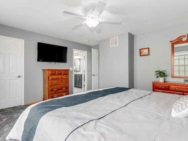 carpeted bedroom with connected bathroom and ceiling fan