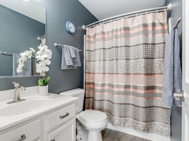 bathroom featuring vanity, hardwood / wood-style floors, a shower with shower curtain, and toilet