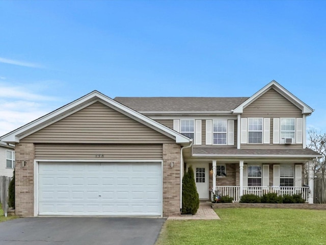 view of front of home with cooling unit, a porch, a garage, and a front yard