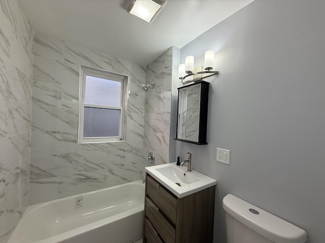 full bathroom with tiled shower / bath, vanity, and toilet