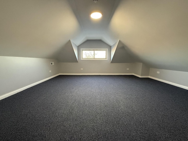 additional living space with lofted ceiling and carpet