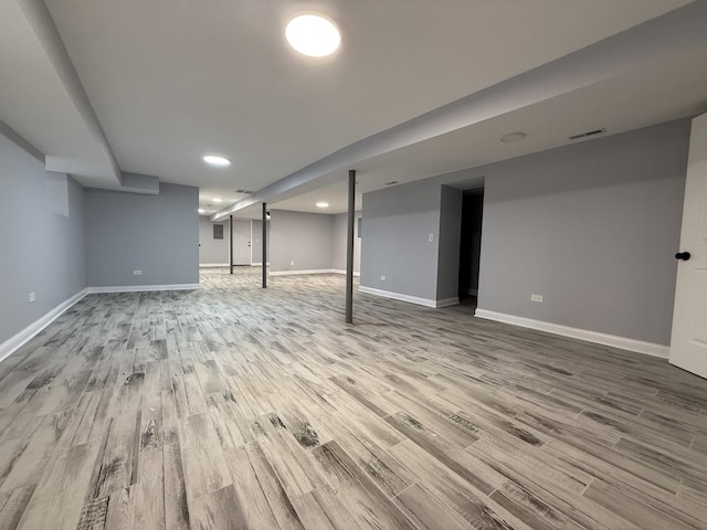 basement with hardwood / wood-style floors