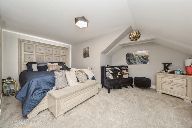 carpeted bedroom with vaulted ceiling