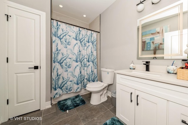 bathroom featuring vanity, walk in shower, and toilet