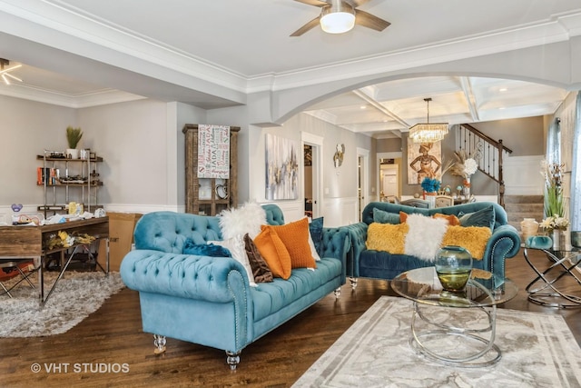 living room featuring dark wood-type flooring, beam ceiling, coffered ceiling, ornamental molding, and ceiling fan with notable chandelier