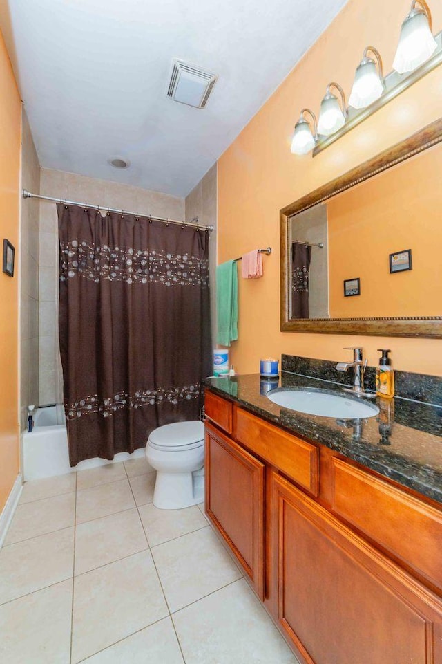 full bathroom featuring tile patterned flooring, vanity, shower / tub combo with curtain, and toilet