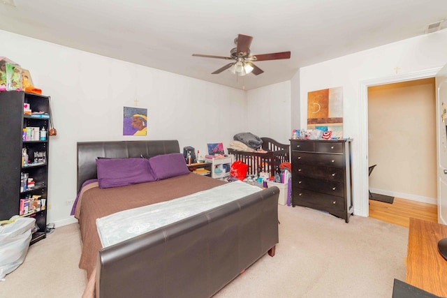 bedroom featuring ceiling fan and light carpet