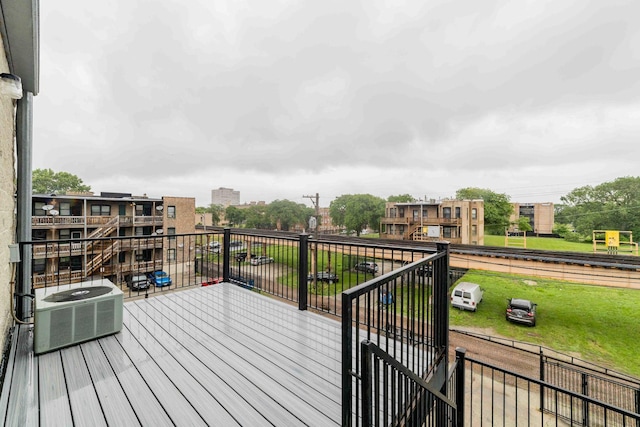 wooden deck featuring cooling unit