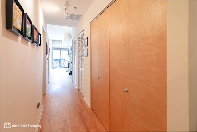 hallway with light hardwood / wood-style flooring