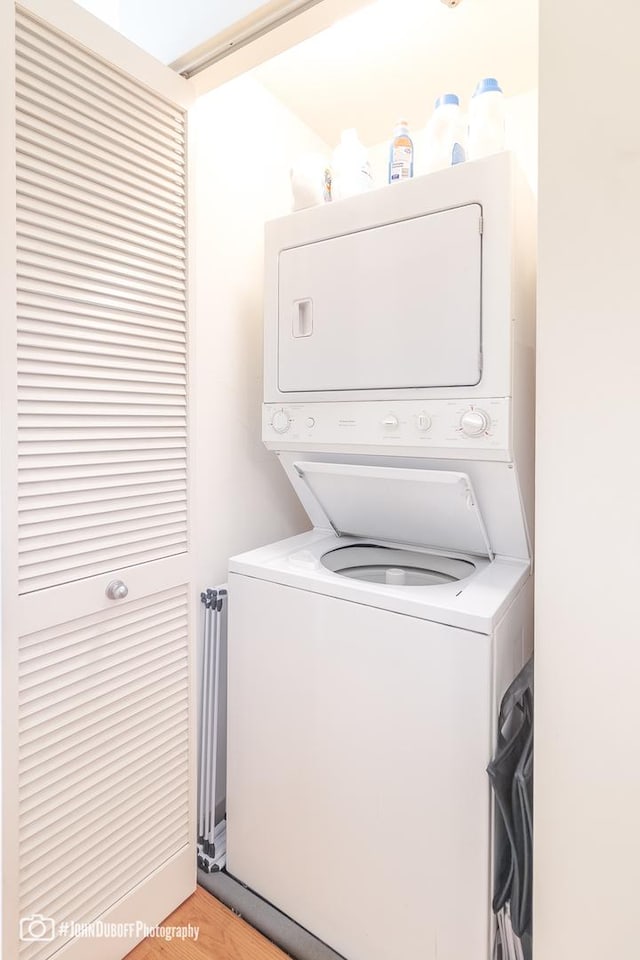 clothes washing area featuring stacked washer and dryer