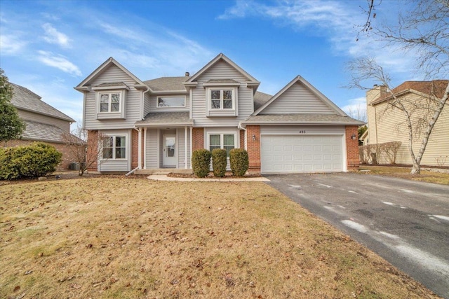 view of front facade featuring a garage and a front lawn