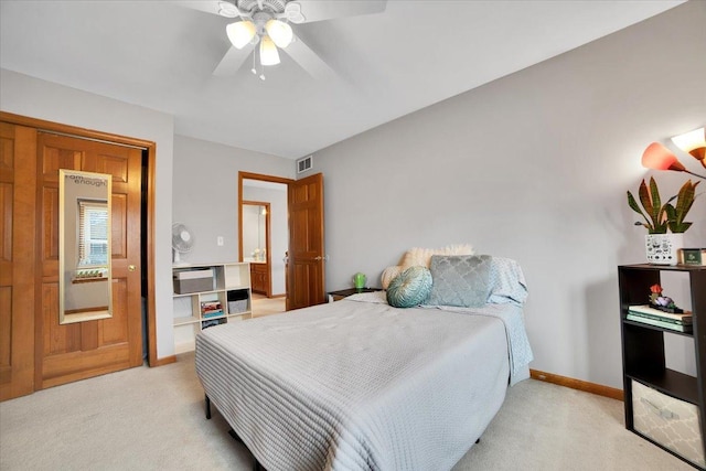 bedroom with ceiling fan and light colored carpet