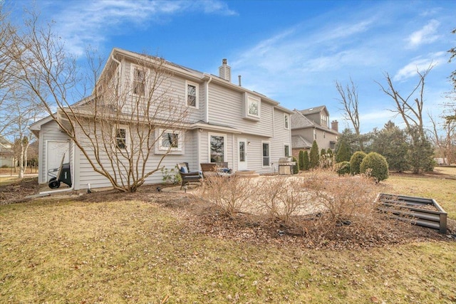 rear view of house featuring a yard