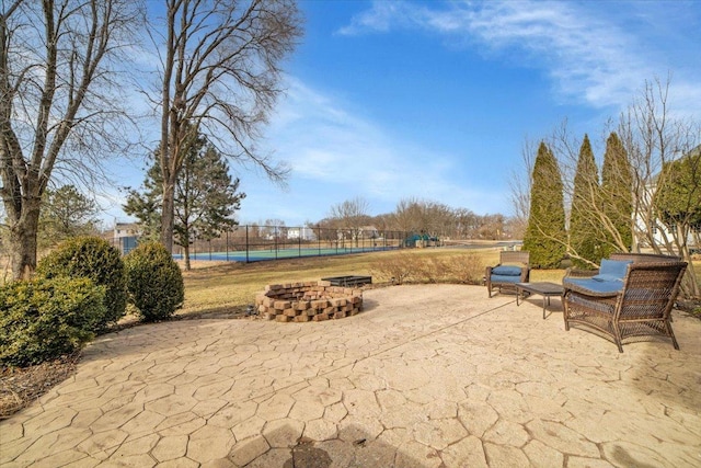 view of patio / terrace featuring an outdoor fire pit