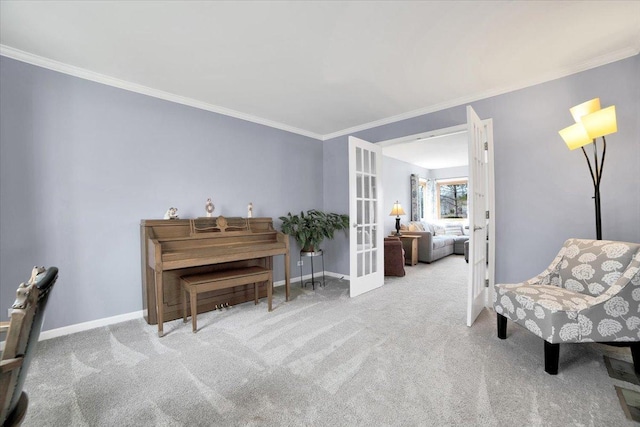 sitting room featuring ornamental molding, light carpet, and french doors