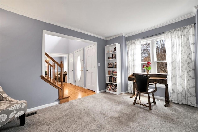 carpeted office space featuring crown molding