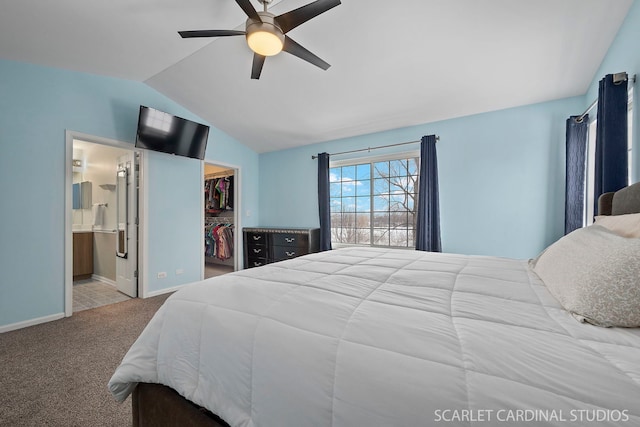 bedroom with ensuite bath, light carpet, a spacious closet, vaulted ceiling, and a closet