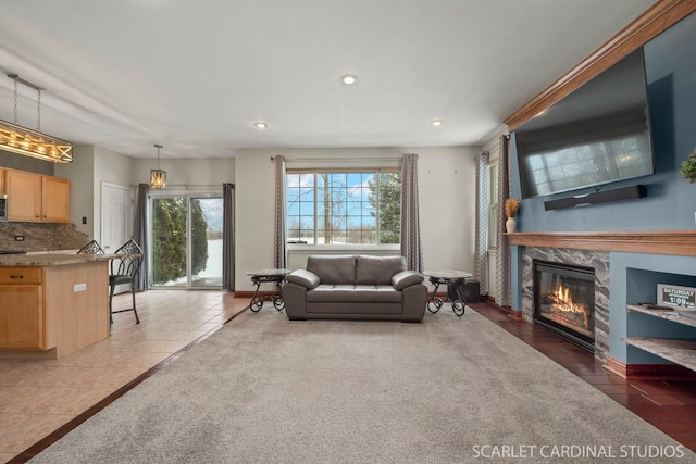 carpeted living room with a high end fireplace