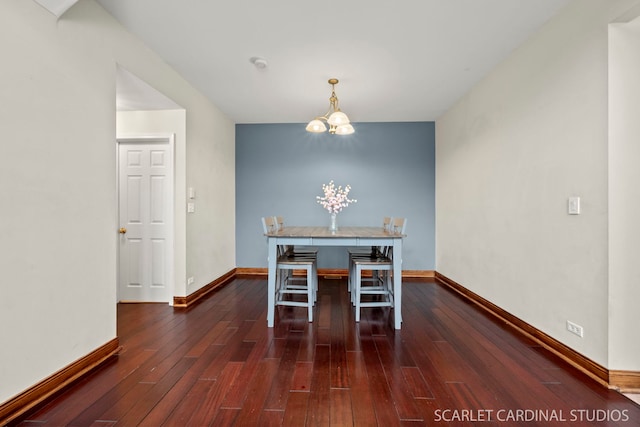 unfurnished dining area with a notable chandelier and dark wood-type flooring