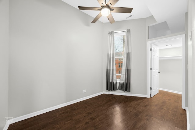 empty room featuring ceiling fan and dark hardwood / wood-style flooring