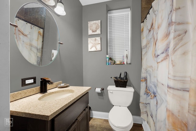 bathroom featuring vanity, a shower with shower curtain, and toilet