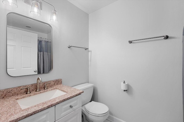 bathroom featuring toilet and vanity