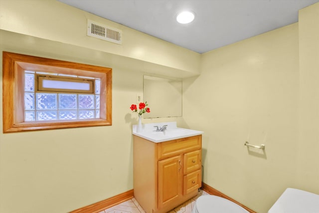 bathroom featuring vanity and toilet