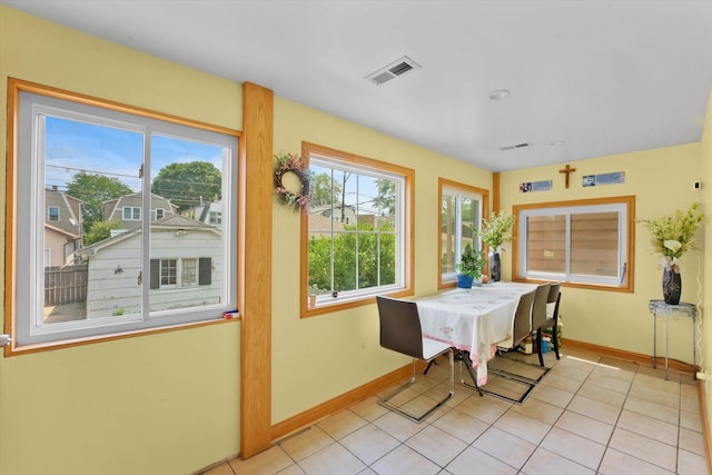 tiled dining space with a healthy amount of sunlight