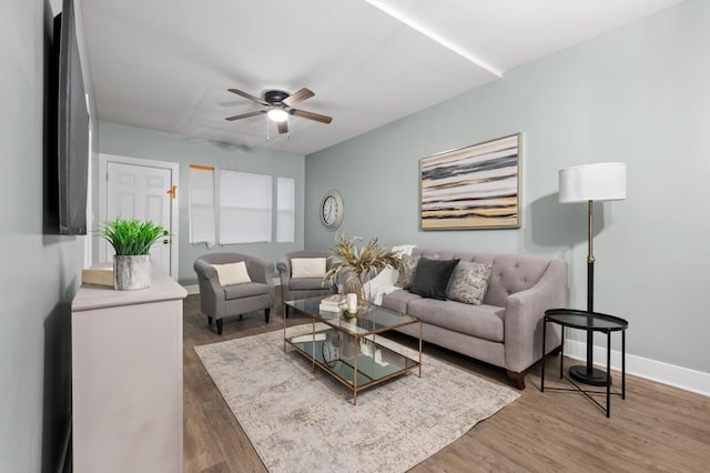 living room with dark wood-type flooring and ceiling fan