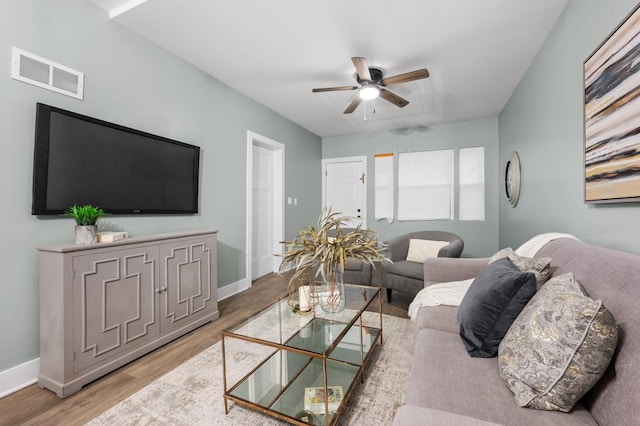 living room featuring hardwood / wood-style floors and ceiling fan