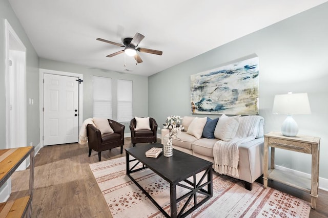 living room featuring hardwood / wood-style flooring and ceiling fan