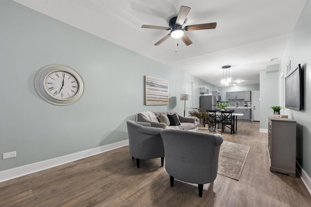 living room featuring hardwood / wood-style flooring and ceiling fan