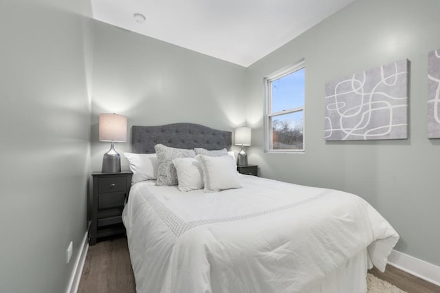 bedroom with dark hardwood / wood-style flooring