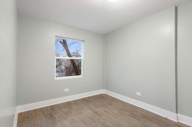 unfurnished room with hardwood / wood-style flooring