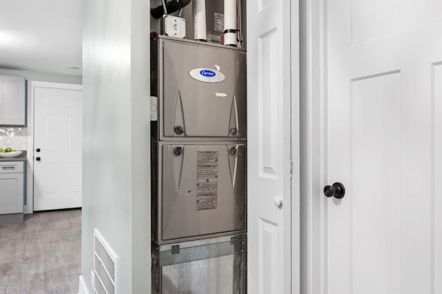 interior space with hardwood / wood-style flooring and decorative backsplash