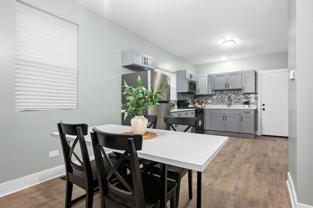 dining area featuring sink and hardwood / wood-style floors