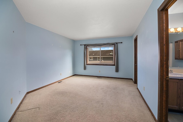 carpeted empty room featuring sink